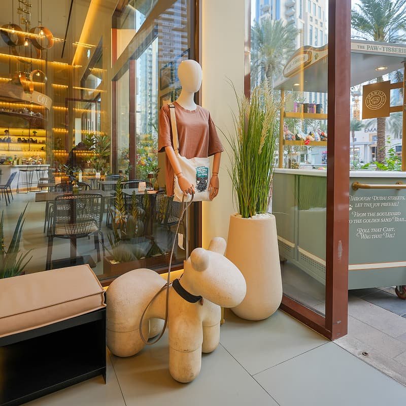 Bright pet hotel reception area with large windows and decorative vases.
