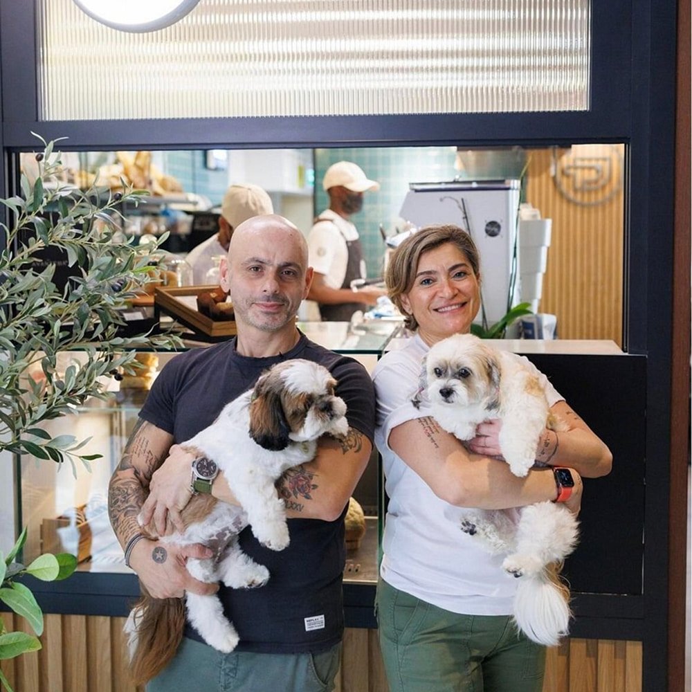 Happy customers with their pet dogs at Pawdy Neighbors pet-friendly restaurant Al Manzil Dubai